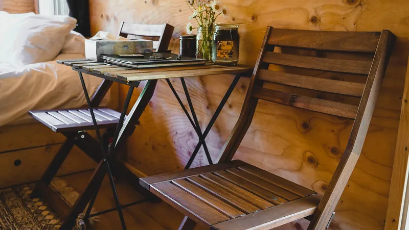 Small table and folding chairs with the furniture in the tiny house was very space efficient Small table and folding chairs with the furniture in the tiny house was very space efficient