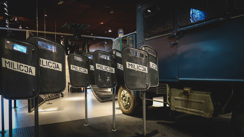 Solidarity museum display in Gdansk featuring military vehicles and police and army shields in Poland 