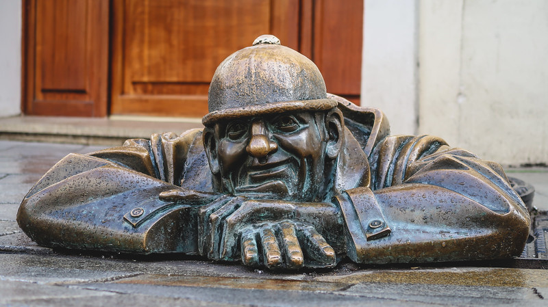 Statue of Čumil The Watcher in Bratislava from a ground level perspective in Slovakia Statue of Čumil The Watcher in Bratislava from a ground level perspective in Slovakia