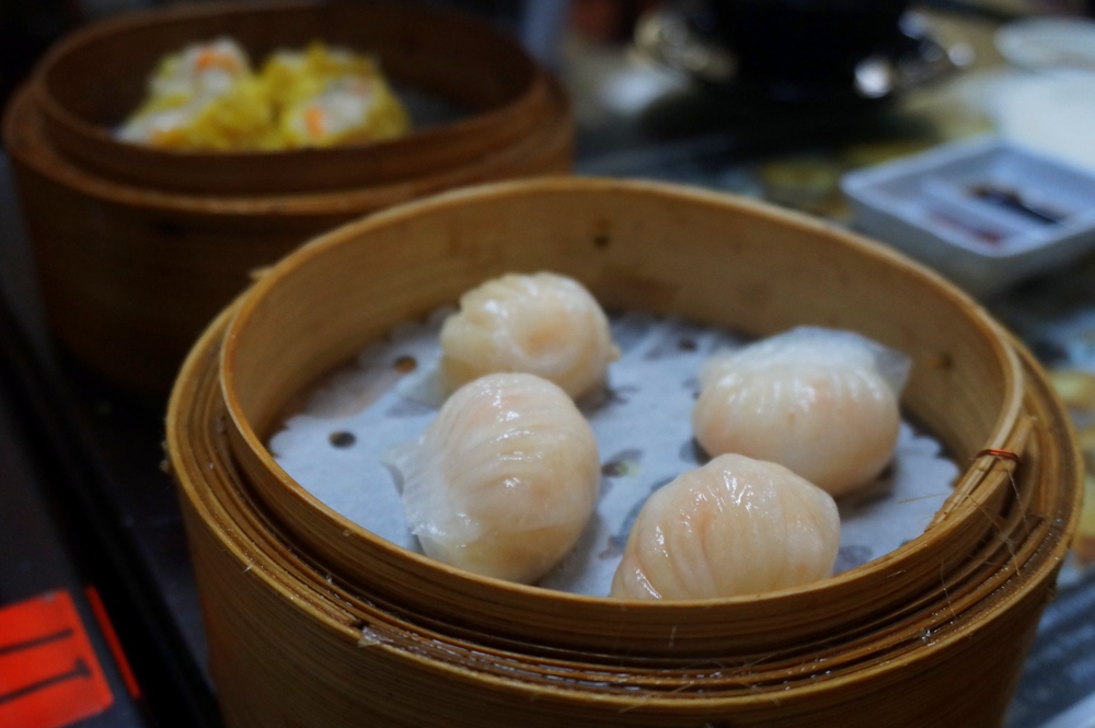 Steamed shrimp dumplings, also known as har gao in Hong Kong served in a wicker basket with four pieces to share
