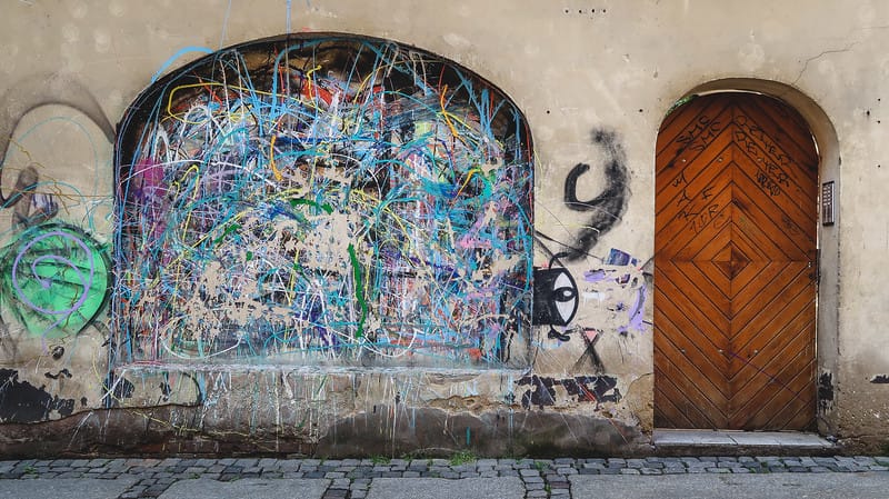 Street art in Poznan on a gritty side street next to a door Street art in Poznan on a gritty side street next to a door
