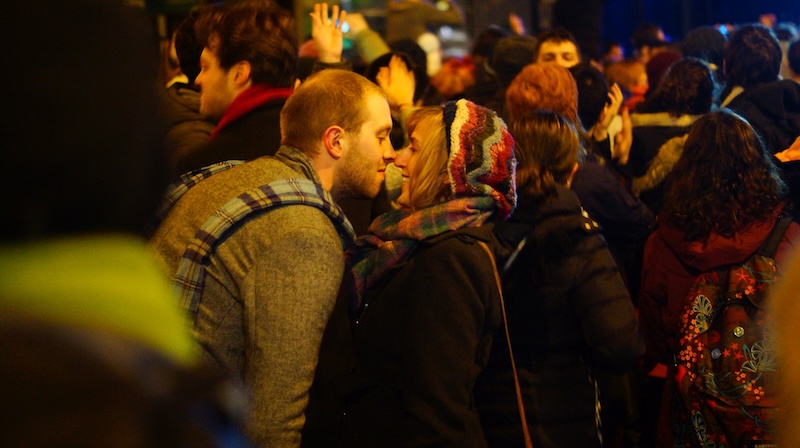 Street party kiss with a big crowd at Hogmanay in Edinburgh, Scotland 