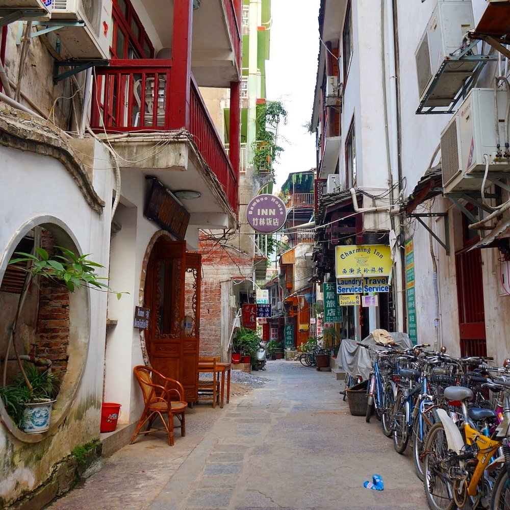 Streets views in Yangshuo, China with guesthouses, businesses, balconies and bicycles park on the side of the street