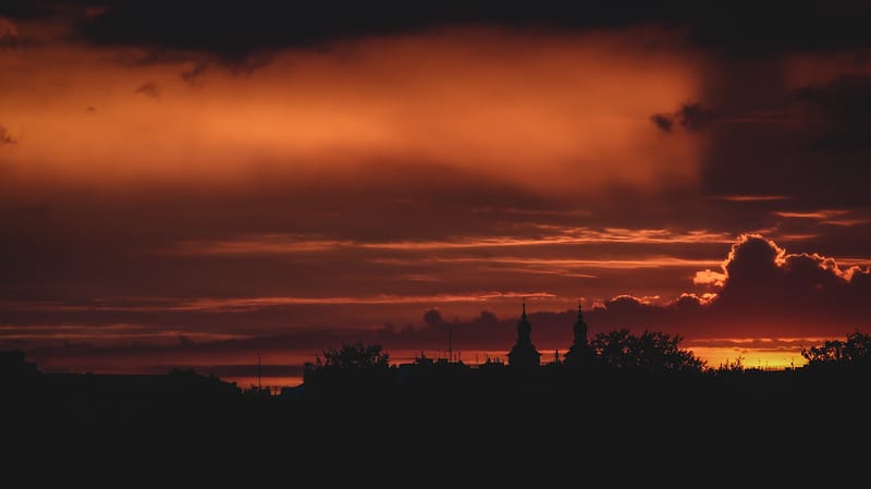 Sunset in Krakow, Poland featuring silhouette buildings from a distant vantage point and clouds on fire Sunset in Krakow, Poland featuring silhouette buildings from a distant vantage point and clouds on fire