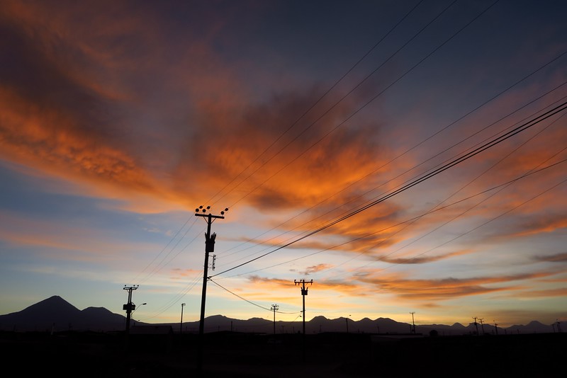 Sunset in San Pedro de Atacama in the city with unique cloud formations and colors and power lines acting as the silhouette subject