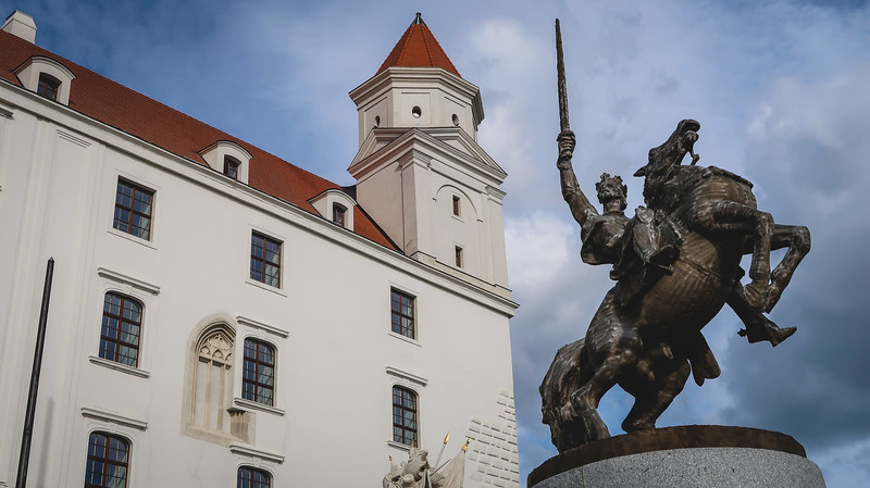 Svätopluk statue in front of Bratislava Castle sword pointed high on top of imposing horse highlighting might and power Svätopluk statue in front of Bratislava Castle sword pointed high on top of imposing horse highlighting might and power