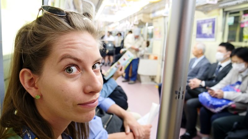 Taking public transportation in Osaka is a smirking That Backpacker Audrey Bergner on the metro subway in Osaka, Japan 
