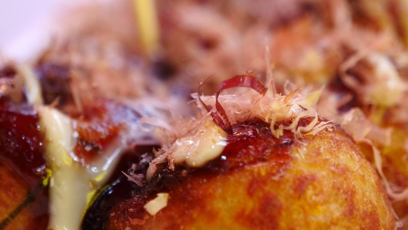 Takoyaki macro details of delicious street food consumed whilst on tour in Osaka, Japan 