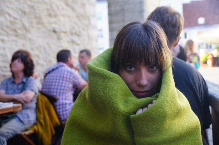 Outdoor café in Tallinn, Estonia providing warm blankets to guests like That Backpacker Audrey Bergner on a cool day during a Helsinki day trip