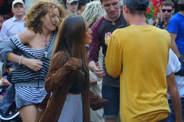 Young people dancing to live medieval folk music during a street festival in Tallinn, Estonia on our Helsinki day trip