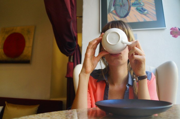 Traveler Audrey Bergner That Backpacker enjoying a cup of rich hot chocolate at a cozy café in Tallinn, Estonia during a day trip