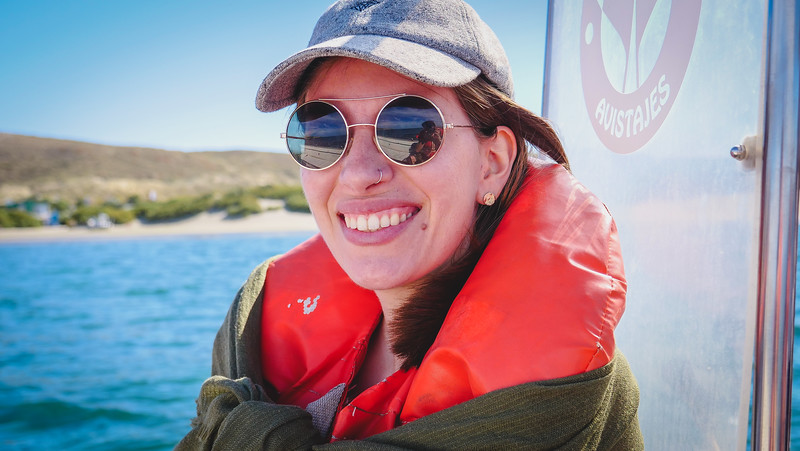 That Backpacker Audrey Bergner all smiles taking a boat excursion to see sea lions in Argentina visiting Peninsula Valdes in Patagonia