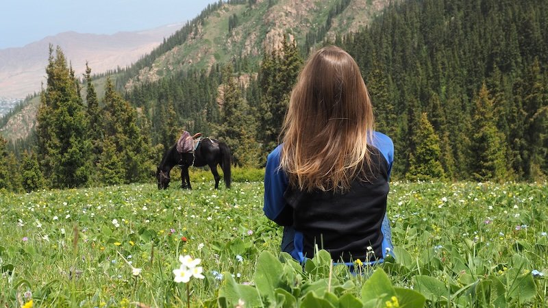 That Backpacker Audrey Bergner and her horse enjoying nature in Kyrgyzstan 