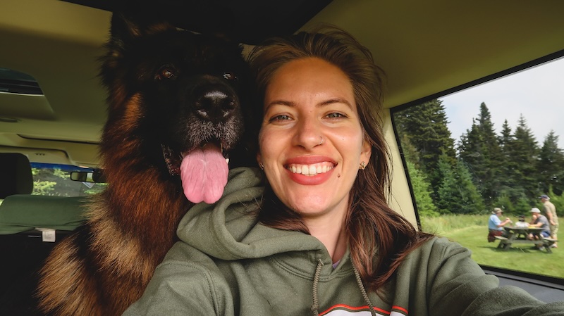 That Backpacker Audrey Bergner and Togo enjoying a happy moment together in the car during a road trip in New Brunswick 