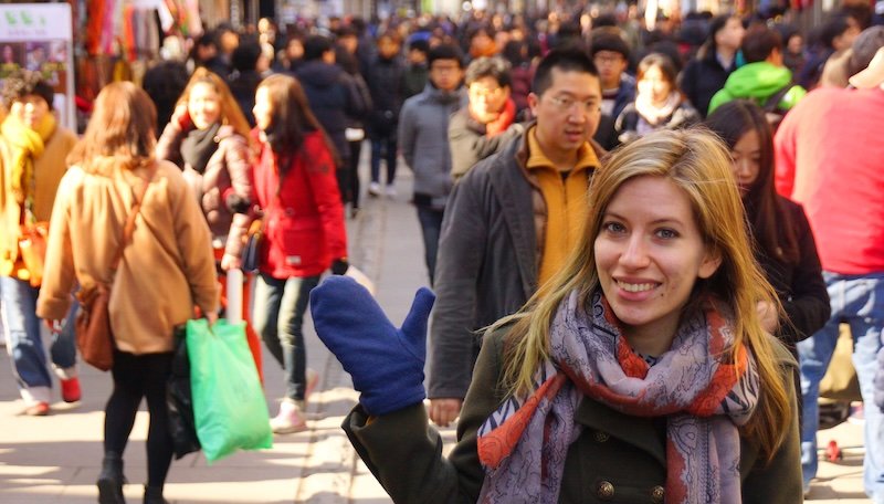 That Backpacker Audrey Bergner enjoying a winter day in Korea with warm gloves waving whilst visiting Insadong, Seoul, Korea 