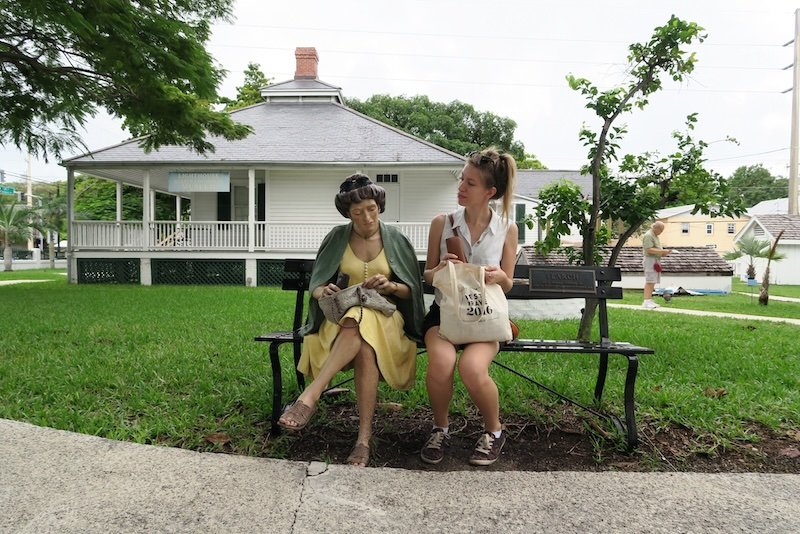 That Backpacker Audrey Bergner enjoying park bench stops visiting Key West, Florida, USA 