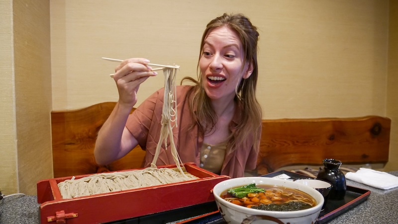 That Backpacker Audrey Bergner enjoying soba noodles with chopsticks in Niigata, Japan 