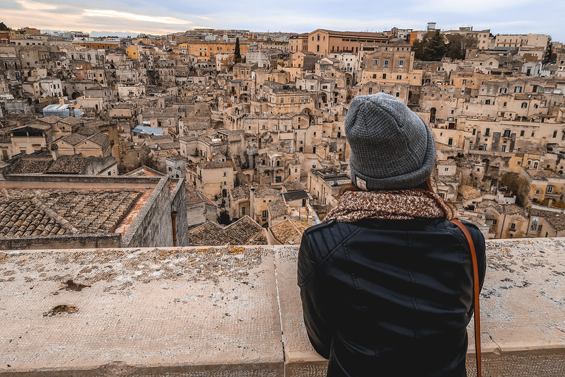 That Backpacker Audrey Bergner enjoying the views of Matera from Matera Cathedral overlooking the historic city center That Backpacker Audrey Bergner enjoying the views of Matera from Matera Cathedral overlooking the historic city center