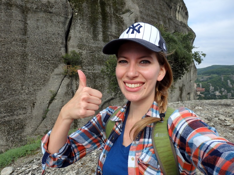 That Backpacker Audrey Bergner giving a thumbs up to hiking in Meteora, Greece 