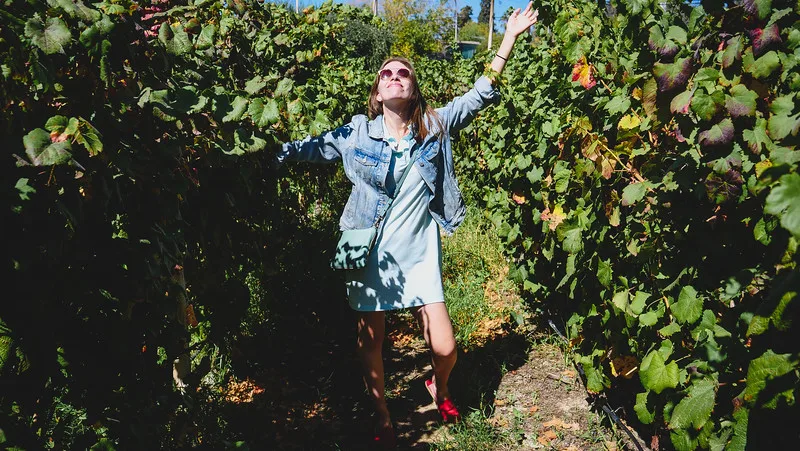 That Backpacker Audrey Bergner having a blast walking through the vineyards at Bodegas Lopez in Mendoza during our visit to Argentina