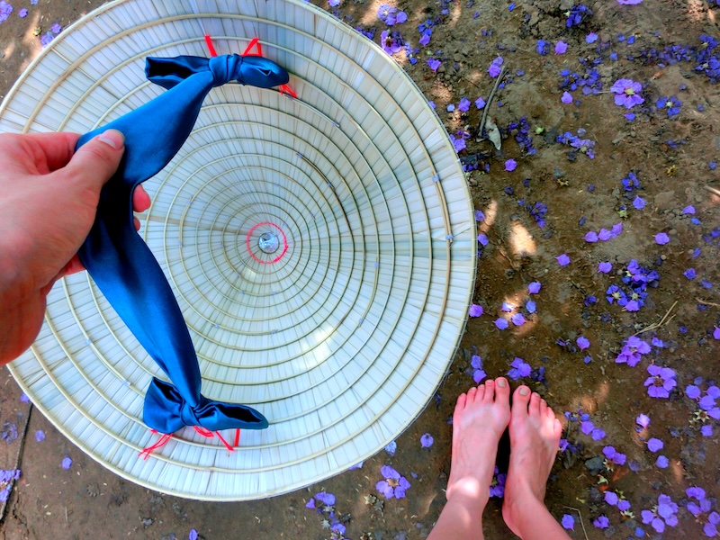 That Backpacker Audrey Bergner holding and dangling her conical hat by her feet in Vietnam 