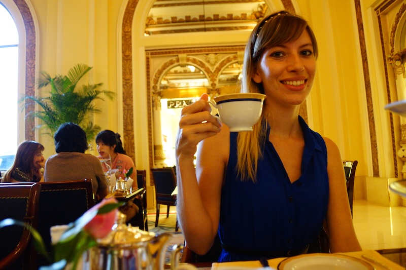 That Backpacker Audrey Bergner holding up a cup of tea and smiling at the Peninsula in Hong Kong, China That Backpacker Audrey Bergner holding up a cup of tea and smiling at the Peninsula in Hong Kong, China