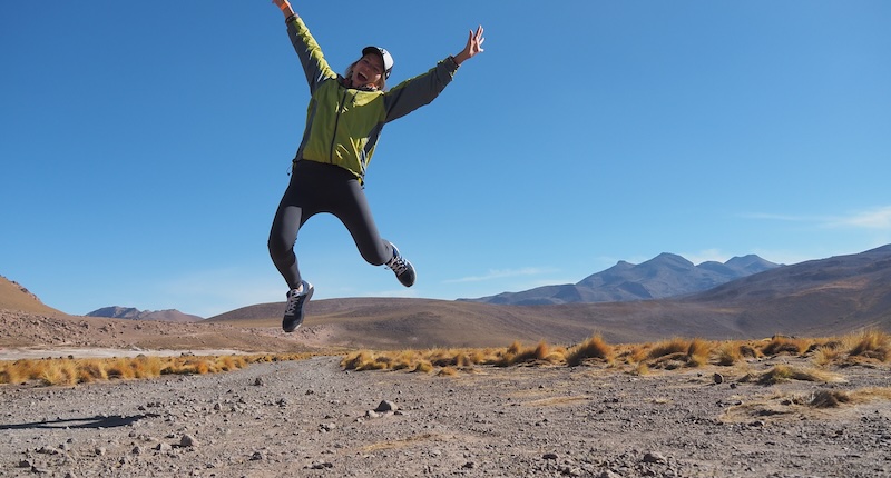 That Backpacker Audrey Bergner jumping for joy visiting Chile in San Pedro de Atacama desert 