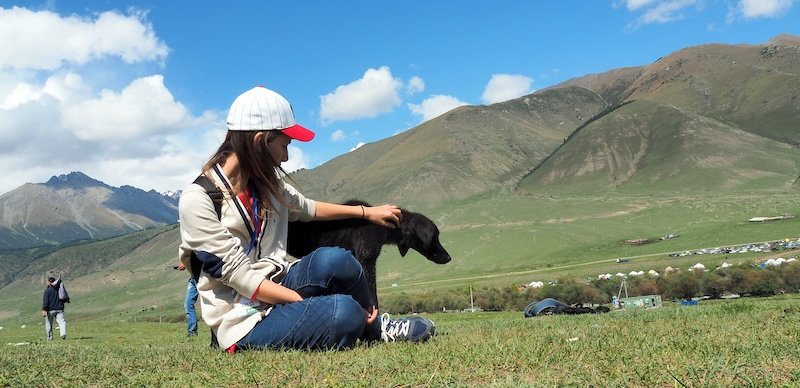 That Backpacker Audrey Bergner making dog friends at the World Nomad Games in Kyrgyzstan 
