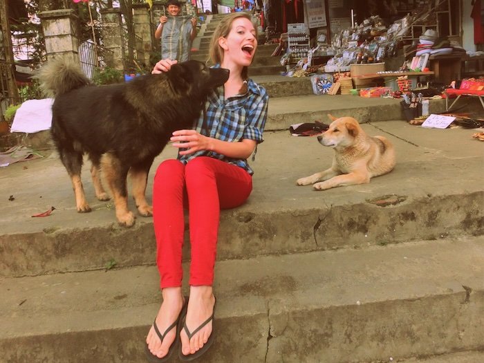 That Backpacker Audrey Bergner making friends with local dogs in Sapa, Vietnam 