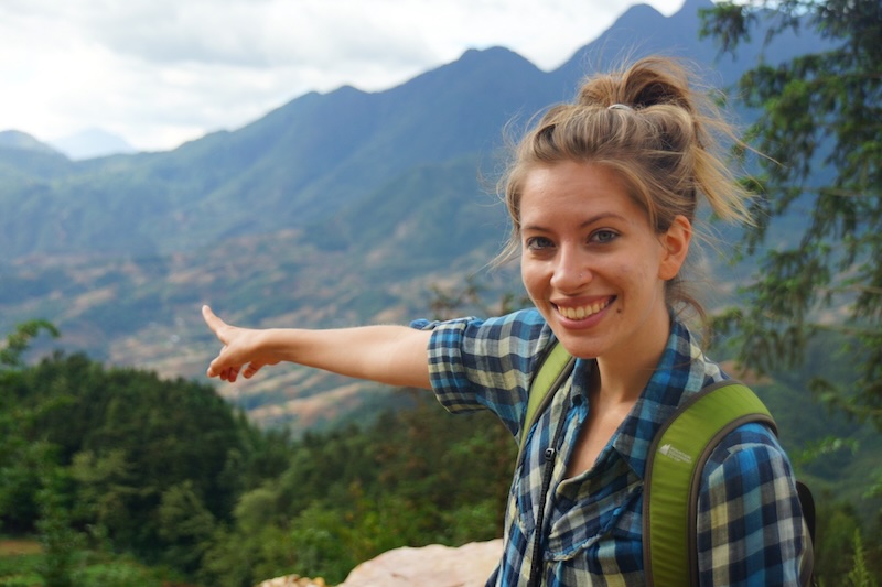 That Backpacker Audrey Bergner pointing to the beautiful scenery hiking in Sapa, Vietnam 