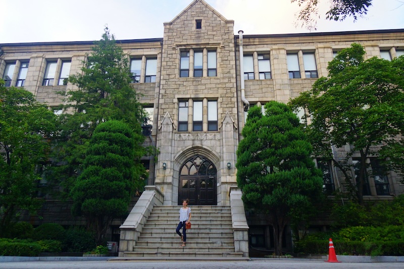 That Backpacker Audrey Bergner posing by a University building at Ewha Woman's University in Seoul, South Korea 