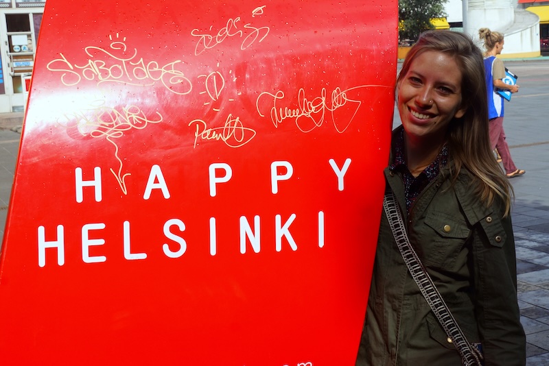 That Backpacker Audrey Bergner posing by Happy Helsinki sign in Finland That Backpacker Audrey Bergner posing by Happy Helsinki sign in Finland
