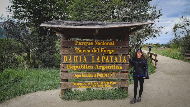 That Backpacker Audrey Bergner posing by sign Bahia Lapataia Tierra del Fuego National Park in Argentina 