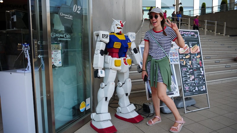That Backpacker Audrey Bergner posing by the Gundam cafe in Odaiba, Japan That Backpacker Audrey Bergner posing by the Gundam cafe in Odaiba, Japan