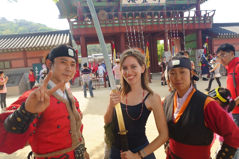 That Backpacker Audrey Bergner posing with Korean martial artists while teaching English in South Korea 