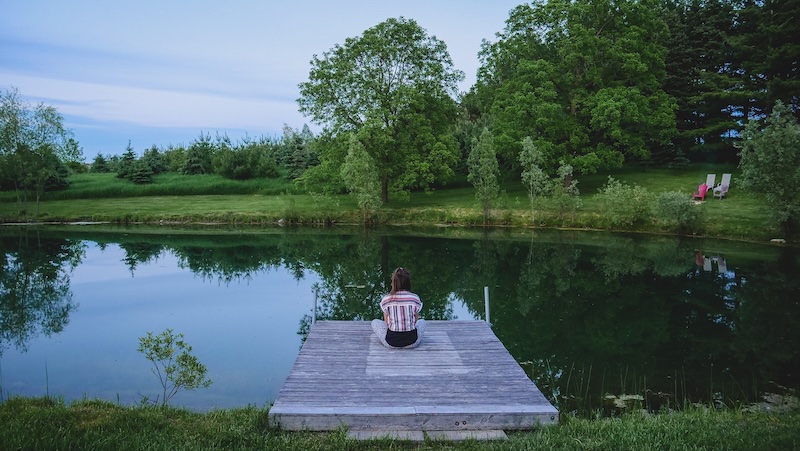 That Backpacker Audrey Bergner relaxing by the pond on an off-grid adventure in Ontario 