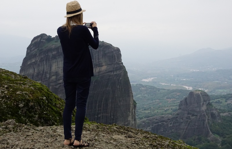 That Backpacker Audrey Bergner taking photos from a high vantage point in Meteora, Greece That Backpacker Audrey Bergner taking photos from a high vantage point in Meteora, Greece