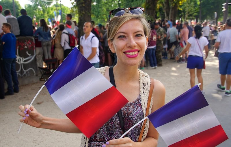 That Backpacker Audrey Bergner visiting France waving French flag in hand 