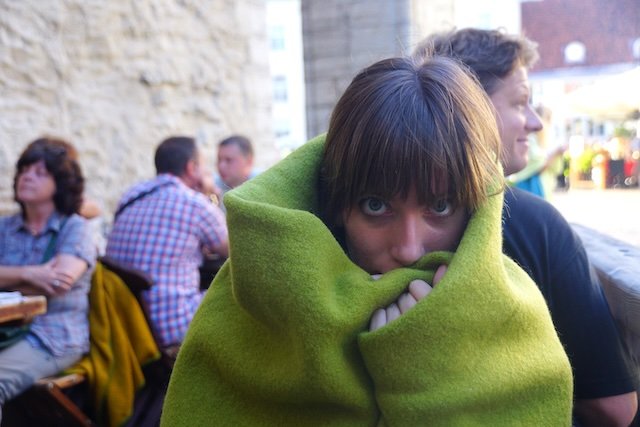 That Backpacker Audrey Bergner warming up with a blanket at Olde Hansa in Tallinn, Estonia 