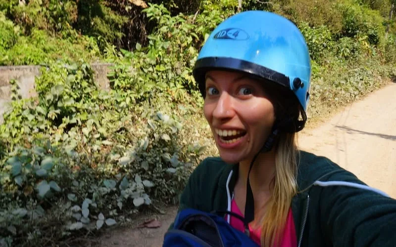 That Backpacker Audrey Bergner wearing a helmet riding a scooter in SE Asia in Pai, Thailand 