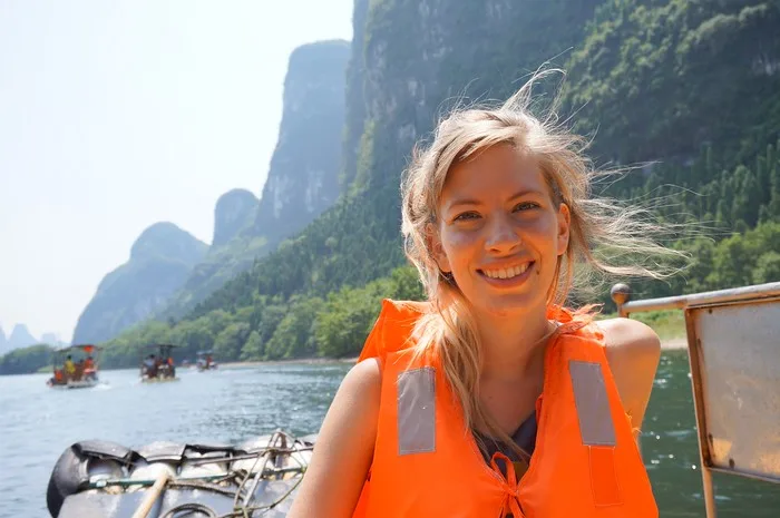 That Backpacker Audrey Bergner wearing an orange life vest on the Li River cruise in China