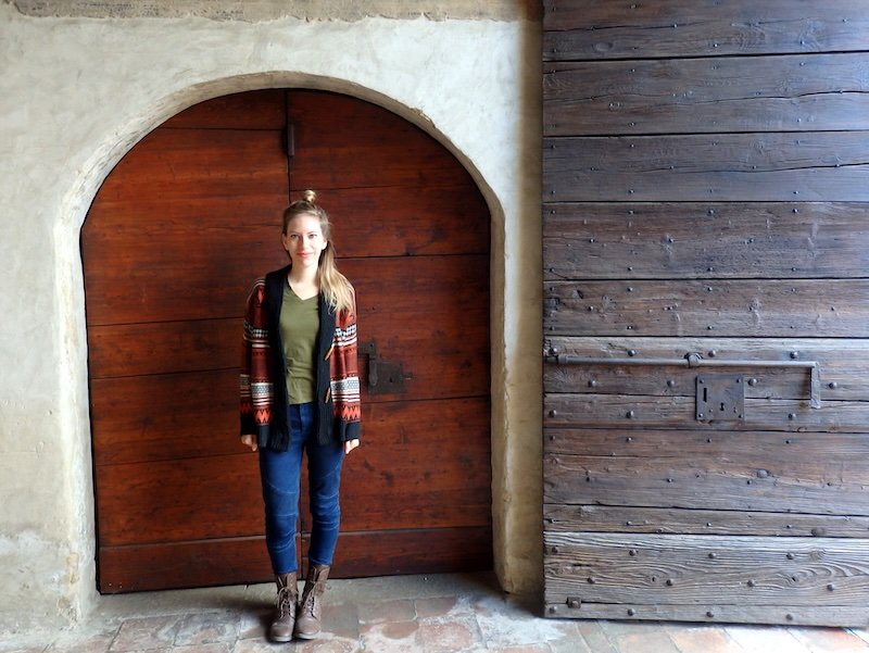 Visiting Lombardy in spring or autumn is jacket weather as indicated by a jumping Audrey Bergner That Backpacker in Milan, Italy That Backpacker Audrey Bergner wearing layers whilst visiting Bergamo, Lombardy, Italy a