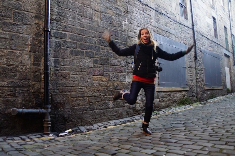 That Backpacker Audrey Bergner jumping for joy excited to explore the spooky and haunted side of Edinburgh, Scotland 