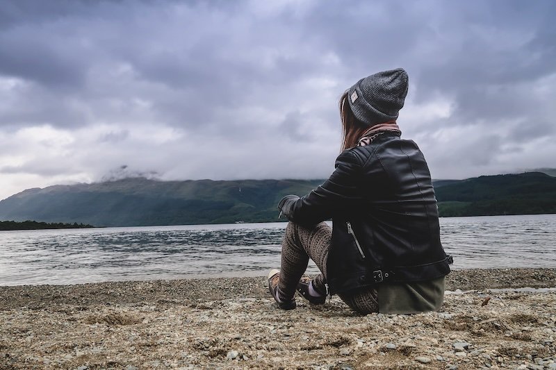That Backpacker Audrey Bergner taking in atmospheric autumn weather and rugged scenery in Argyll, Scotland wearing warm beanie in Europe 