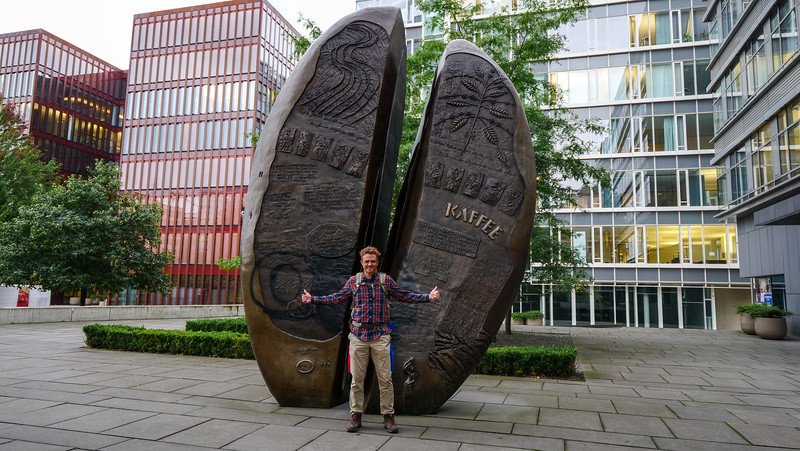The coffee bean sculpture at the Coffee Plaza in Hamburg, Germany with two thumbs up from Nomadic Samuel for sense of scale The coffee bean sculpture at the Coffee Plaza in Hamburg, Germany with two thumbs up from Nomadic Samuel for sense of scale