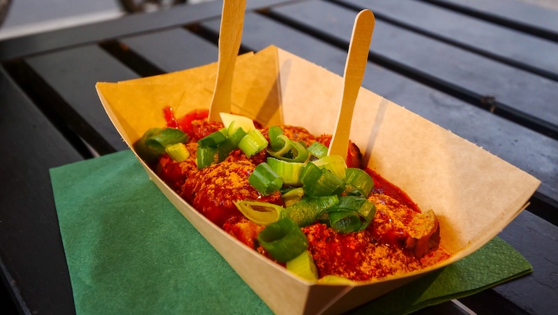 The currywurst ready to be devoured as a street food snack in all of its glory in Berlin, Germany 