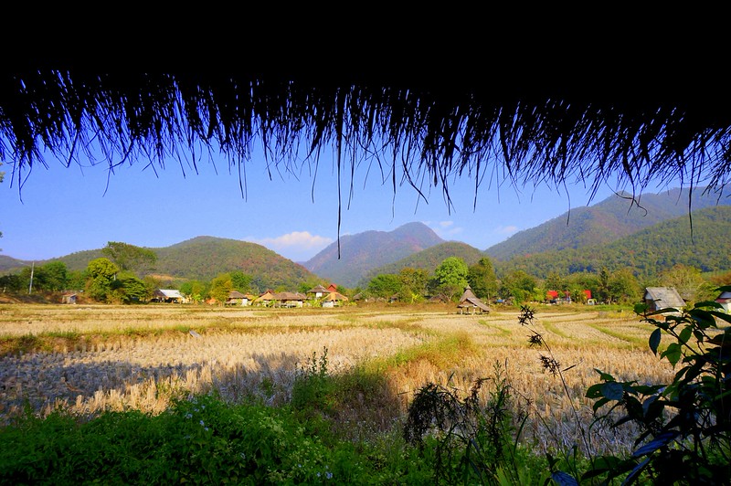 The hippie town of Pai in Northern Thailand with views from our hut where you can see lush mountains off in the distance and a village nearby