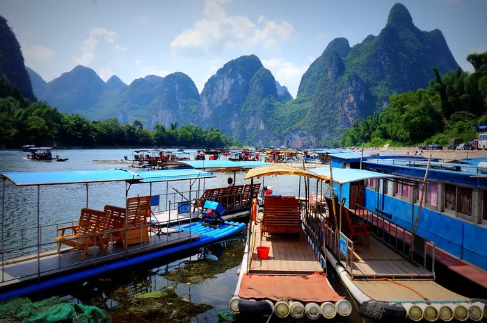 The plastic "bamboo" rafts that take you down the Li River docked at the loading port with karst mountain views