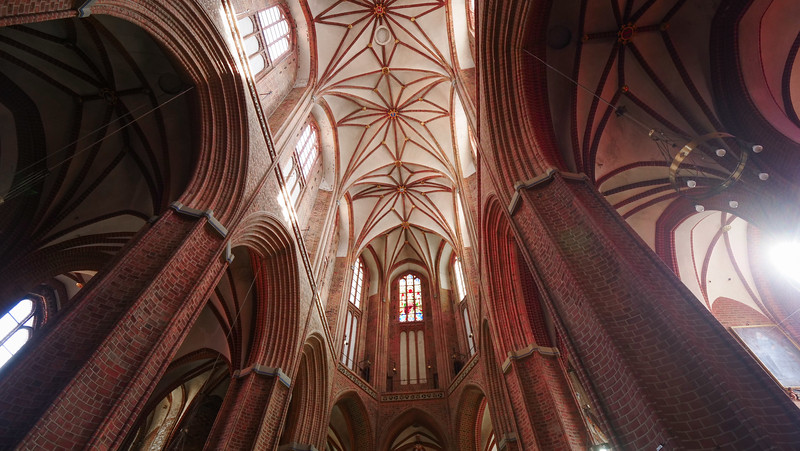 The red brick arches of the Basilica of St Nikolai in Lüneburg, Germany from a low vantage point