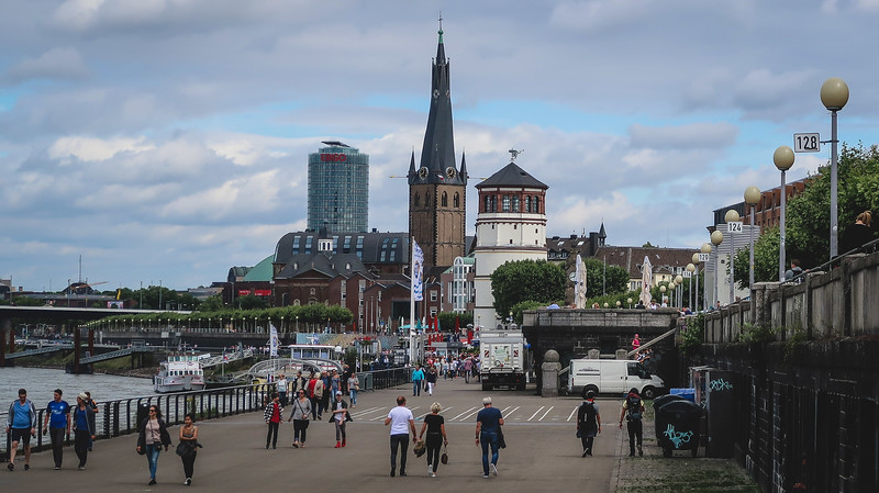 The Rhine River Promenade in Düsseldorf with pedestrians enjoying the scene in Germany 